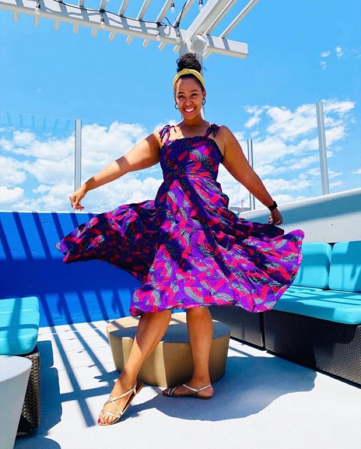 Sidney twirling in a purple Rent the Runway dress on a boat deck